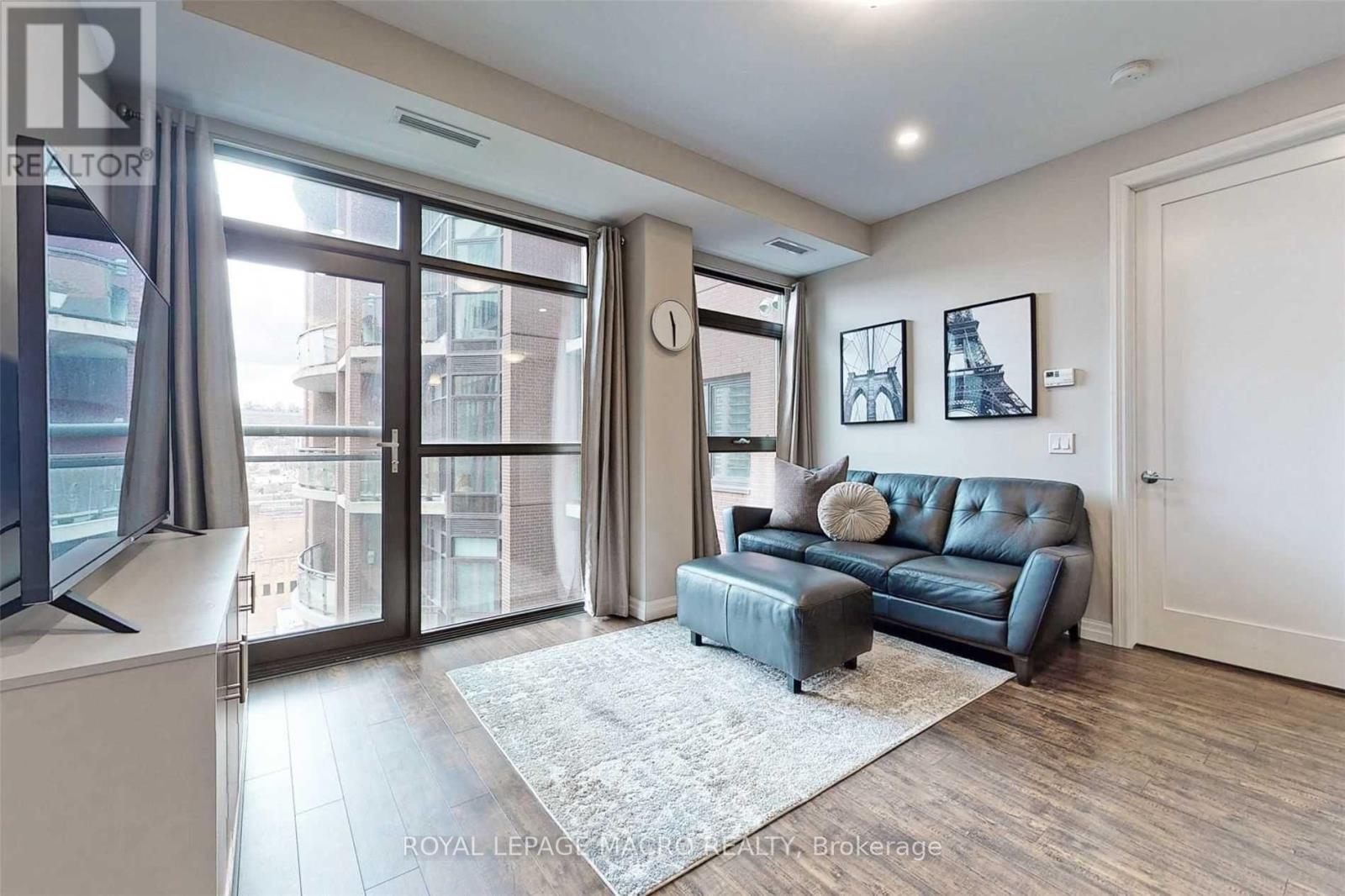 A living room with a blue couch and a flat screen TV.
