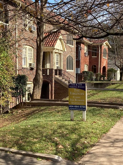 A sign in front of a house that says The Virginian.
