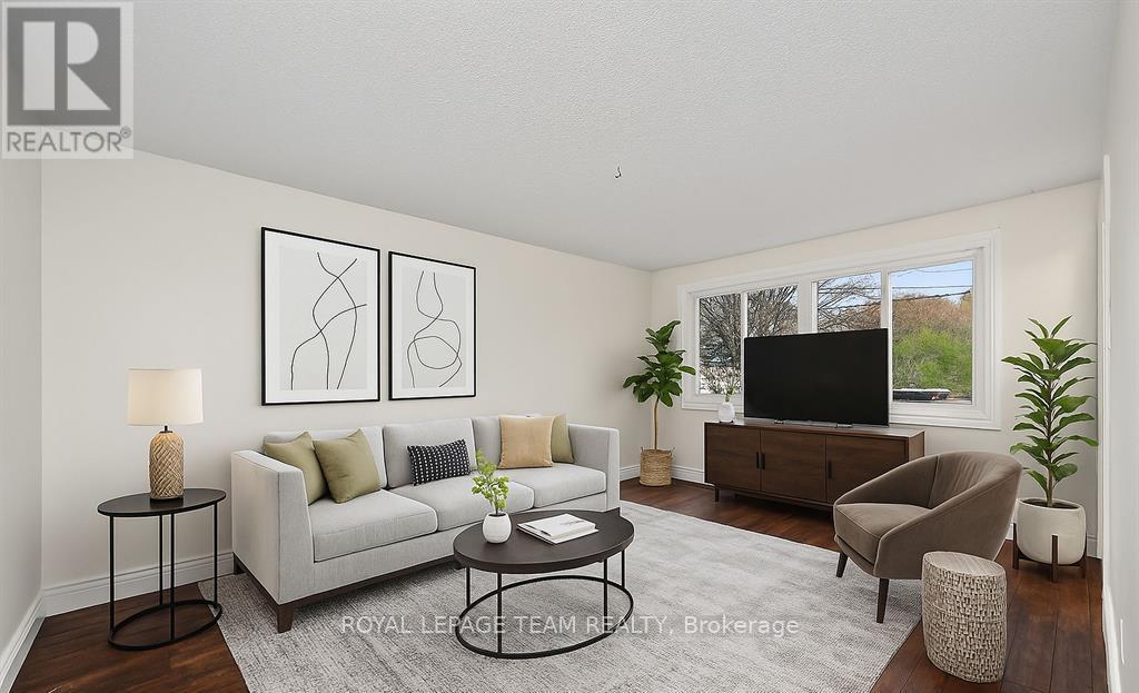 A living room with a grey sofa, a black coffee table, and a flat screen TV.