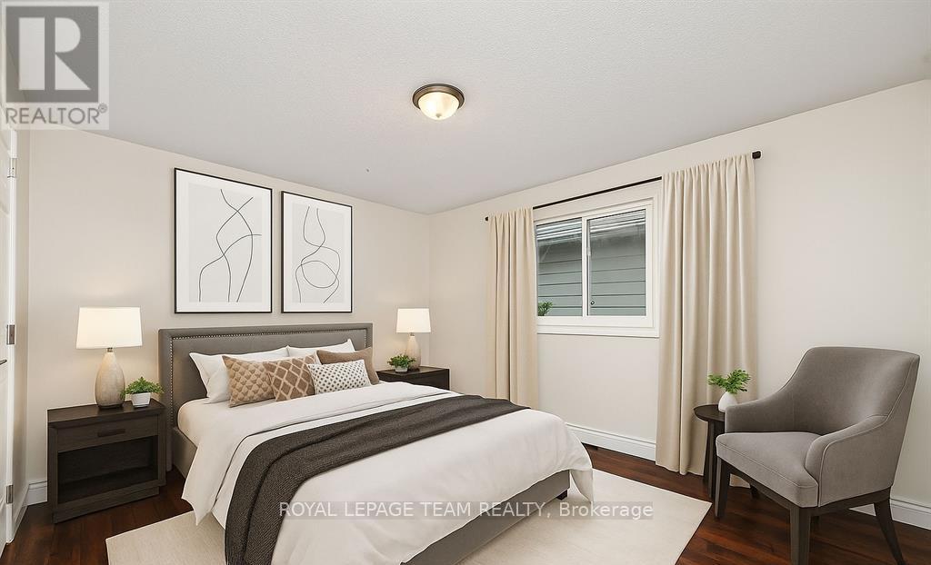 A bedroom with a bed, chair, and two lamps.