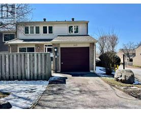 A two-story house with a garage and a driveway in front.