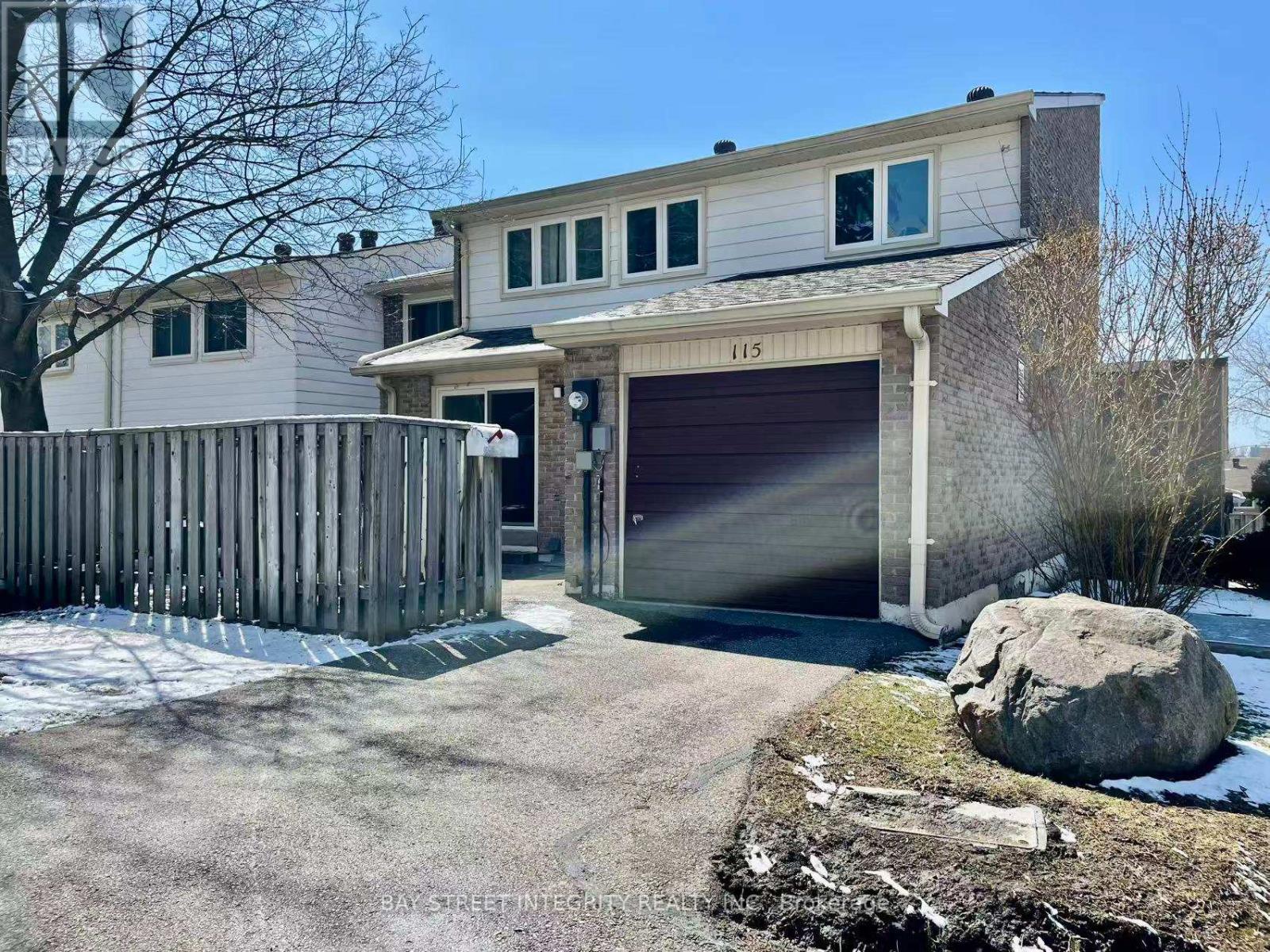 A two-story house with a garage and a driveway.
