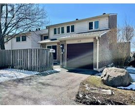 A two-story house with a garage and a driveway.