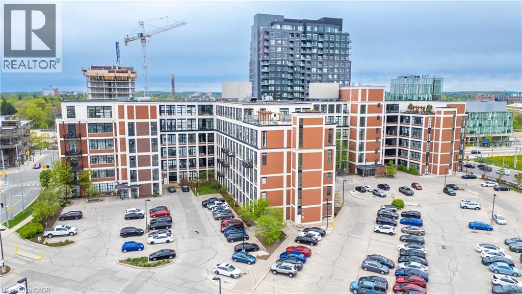A parking lot with cars and a building in the background.