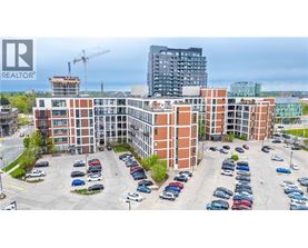 A parking lot with cars and a building in the background.