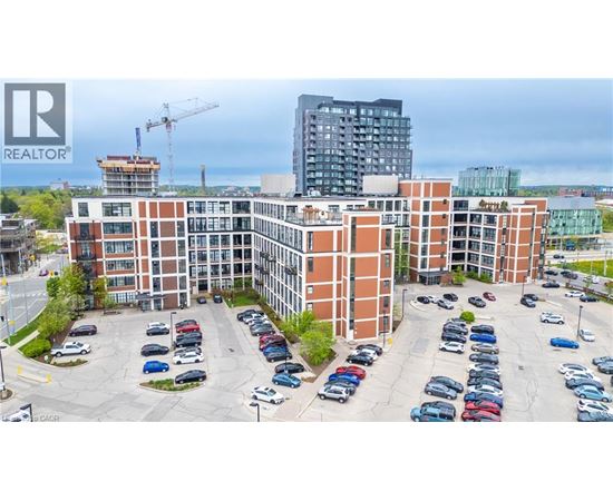 A parking lot with cars and a building in the background.