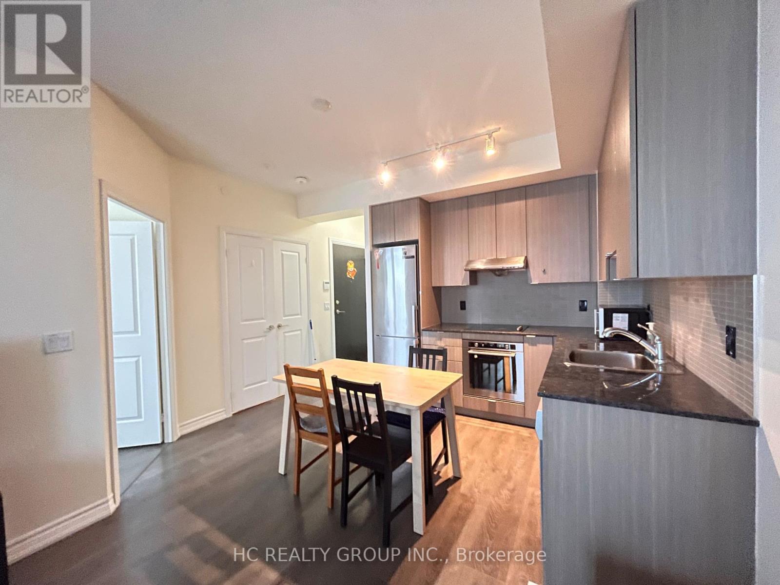 A kitchen with a table and chairs in the middle of the room.