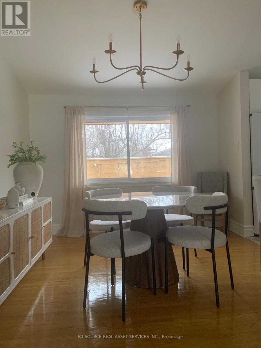 A dining room with a table set for four.
