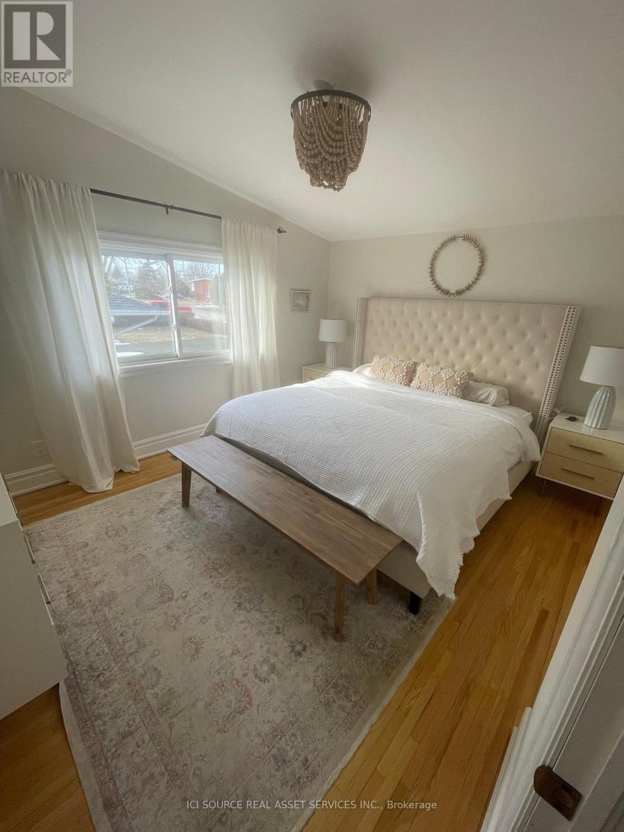 A bedroom with a large bed and a chandelier.