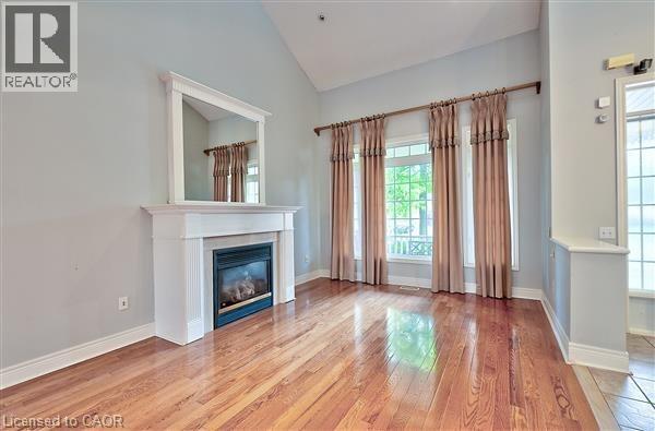 A living room with a fireplace and wood flooring.