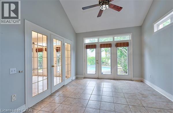 A spacious room with a ceiling fan and sliding glass doors.