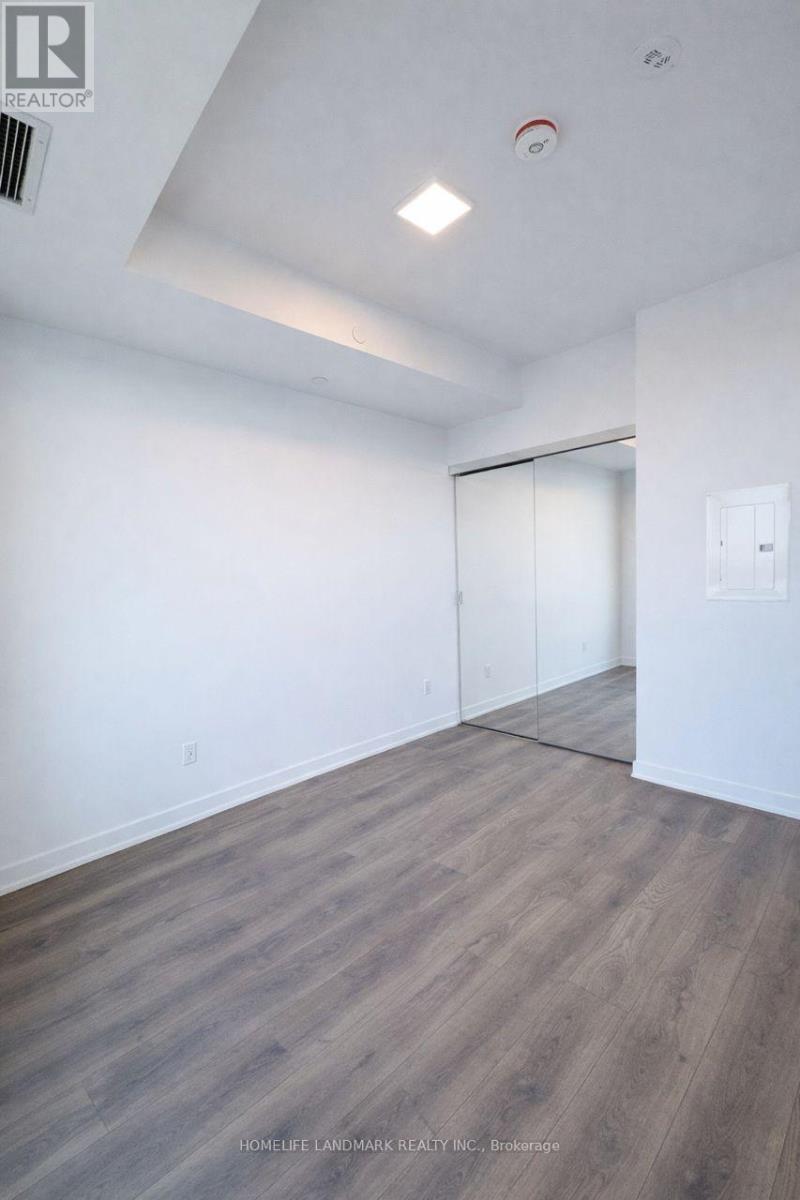 A room with a wooden floor and white walls.
