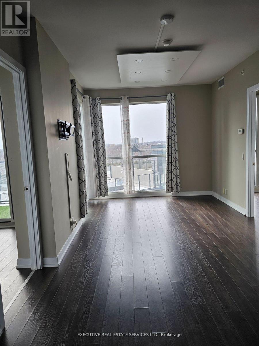 A room with a sliding glass door leading to a balcony.