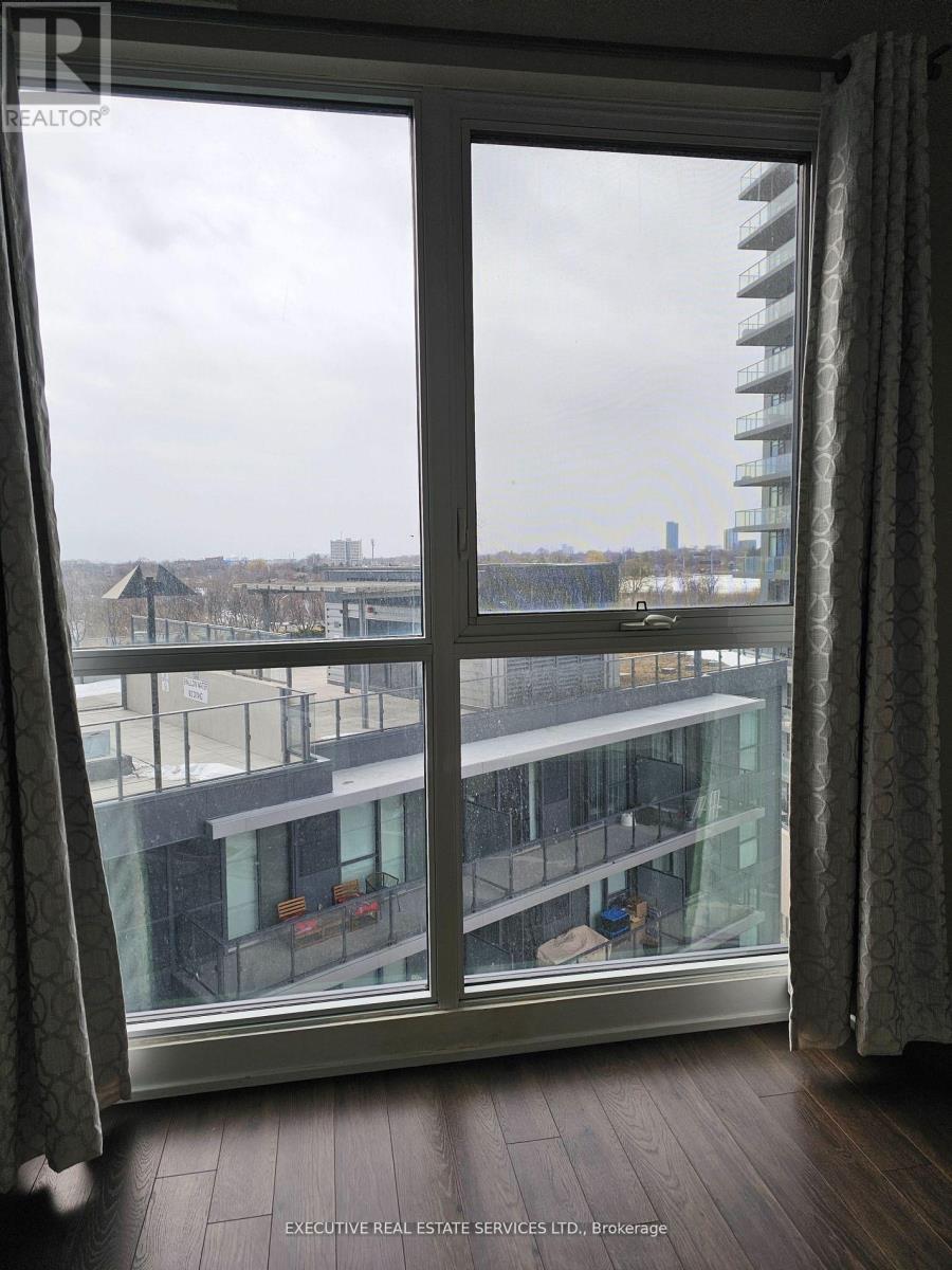 A view from a window looking out at a cityscape.