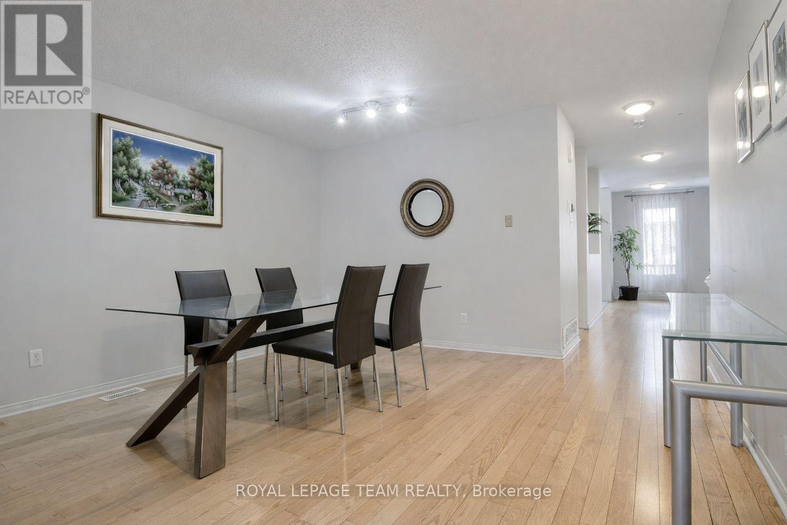 A dining room with a glass table and chairs.