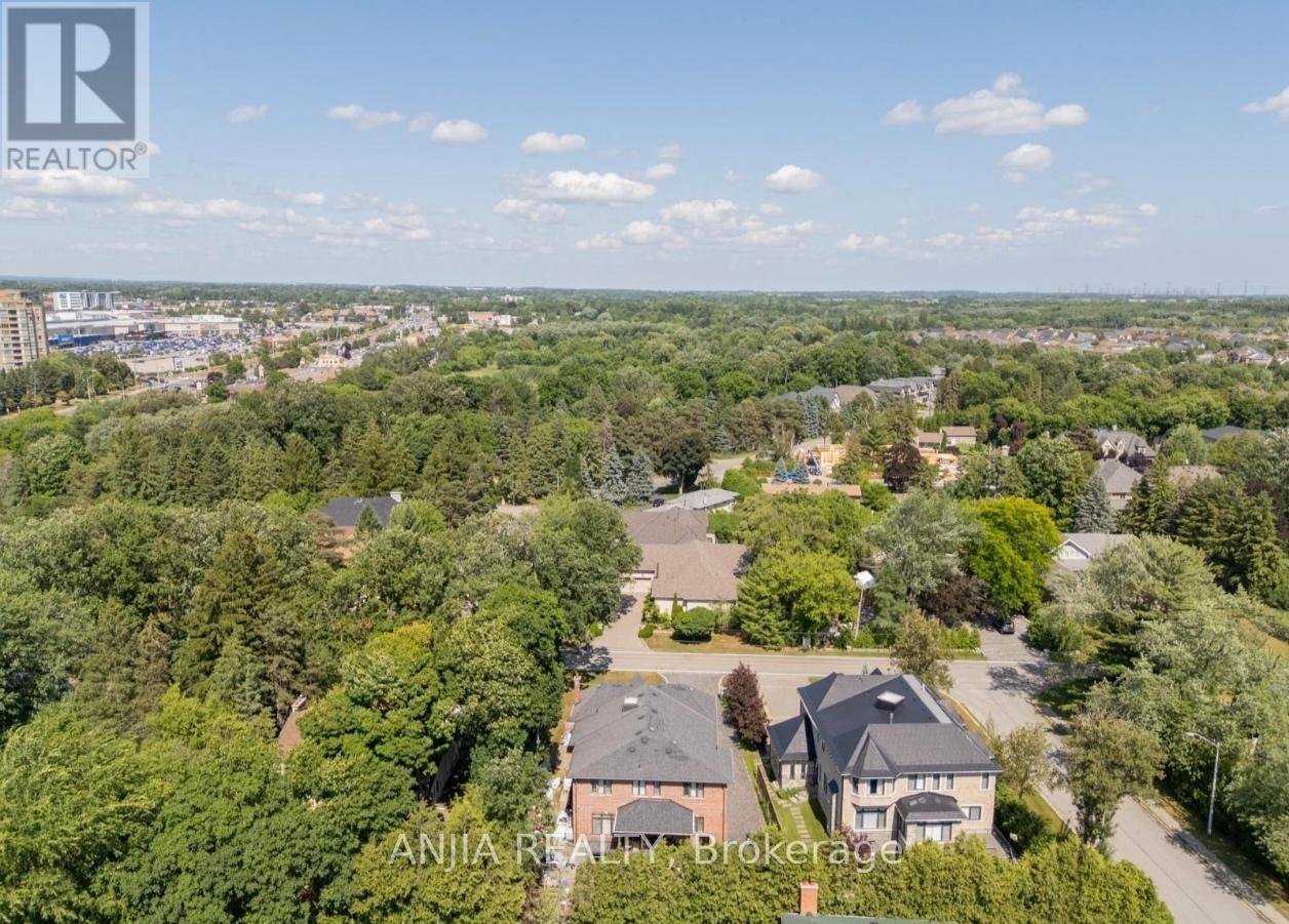 A bird's eye view of a residential area with houses and trees.