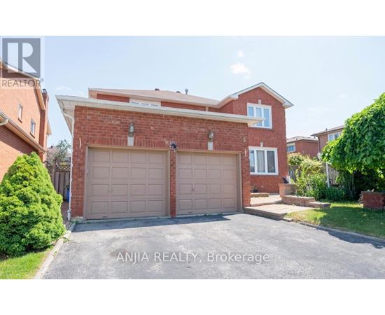 A house with a brick facade and a large garage door is for sale through Anjia Realty in Brokerage.
