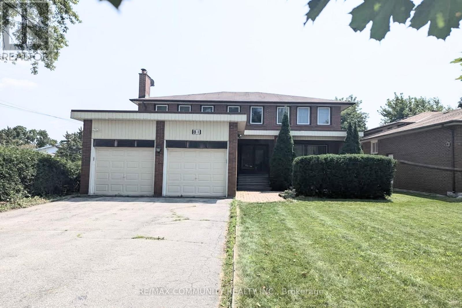 A two-story house with a garage and a driveway.