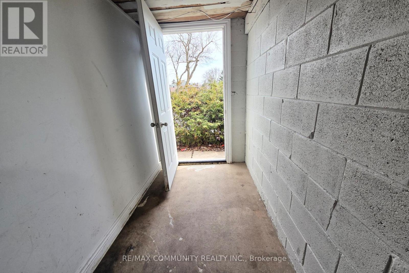 A hallway with a door leading to a backyard.