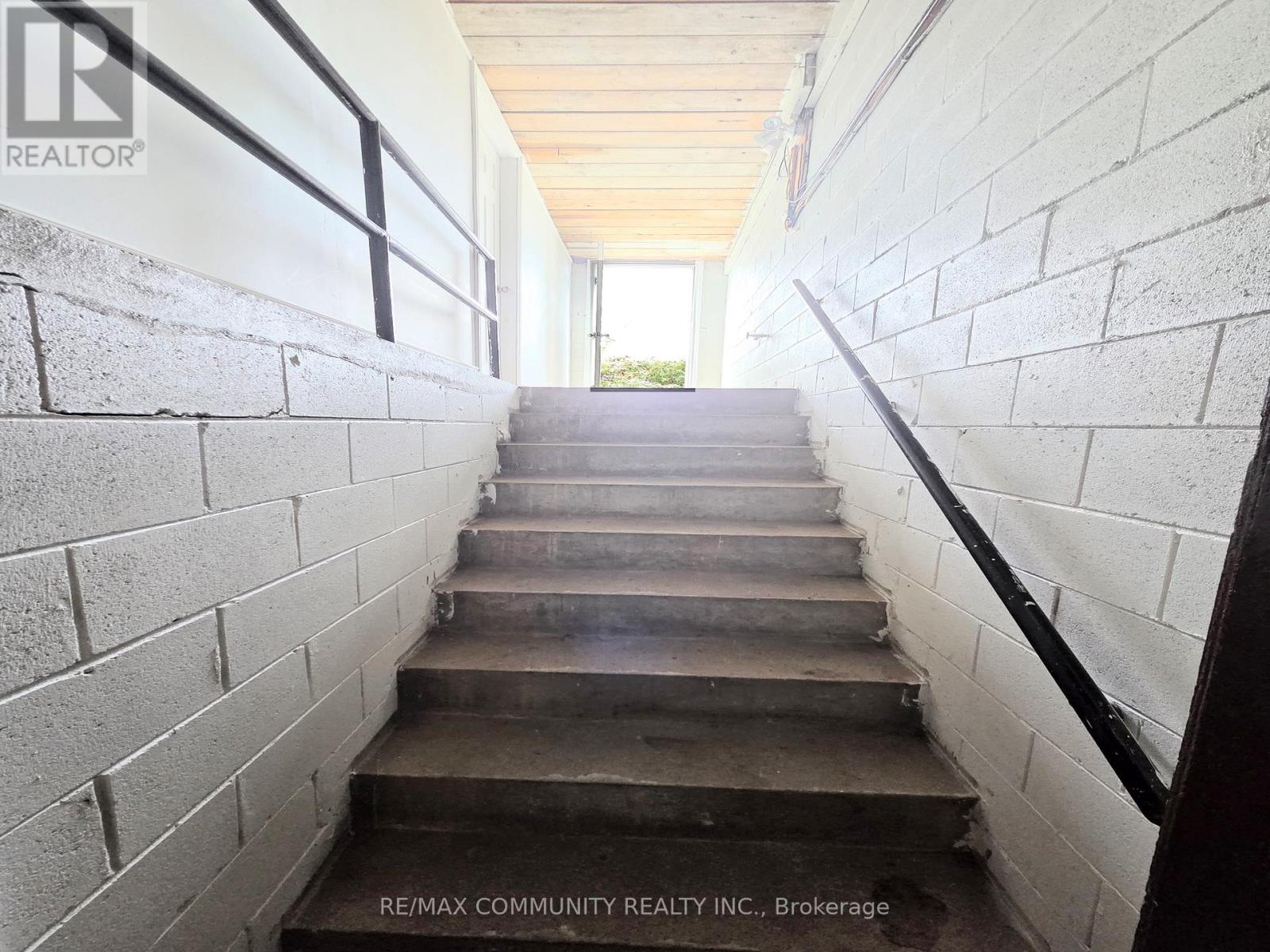 A flight of concrete stairs leads up to a doorway.