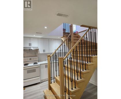 A staircase with a black railing and wooden steps.