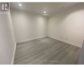 A room with a grey floor and white walls.