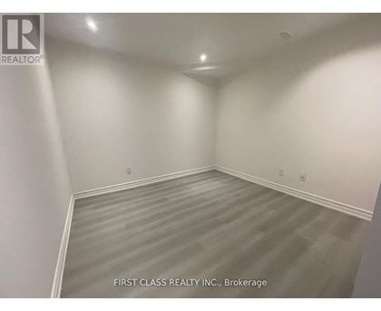 A room with a grey floor and white walls.