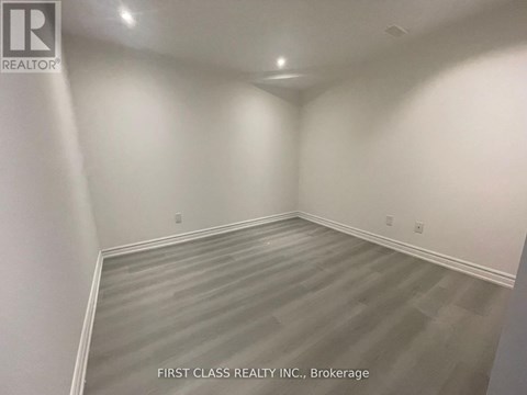 A room with a grey floor and white walls.