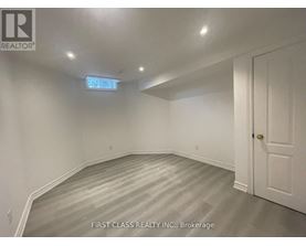 A room with a wooden floor and white walls.