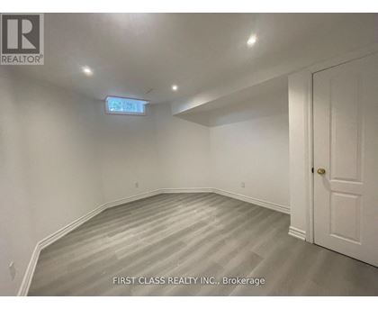 A room with a wooden floor and white walls.
