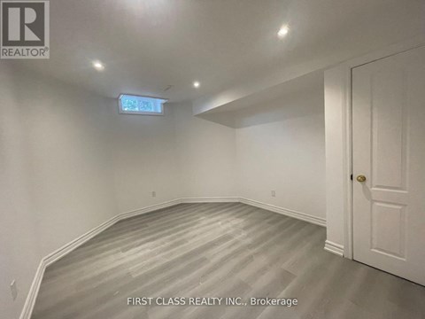 A room with a wooden floor and white walls.