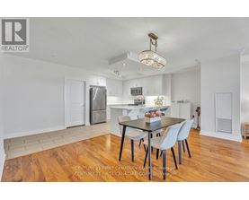 A dining room with a wooden table and chairs.