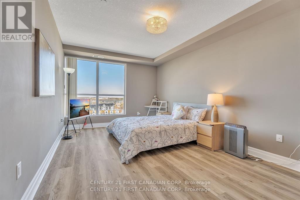 A bedroom with a large bed and a view of the city.