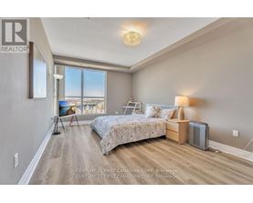 A bedroom with a large bed and a view of the city.