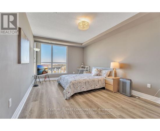 A bedroom with a large bed and a view of the city.