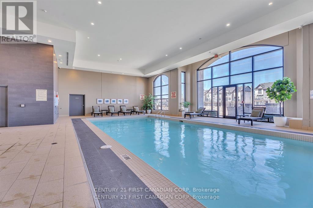 A large indoor swimming pool with a view of the city.