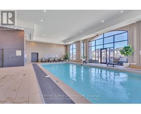 A large indoor swimming pool with a view of the city.
