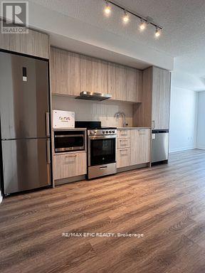A modern kitchen with wooden cabinets and stainless steel appliances.
