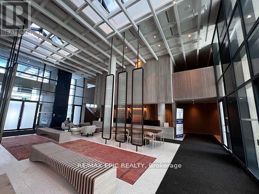 A modern living room with a red carpet and a glass ceiling.