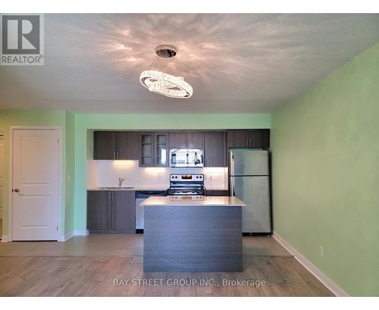 A kitchen with a refrigerator, stove, and oven.