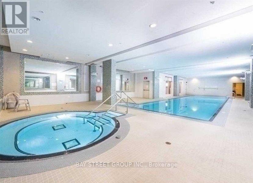 A swimming pool inside a building with a sign that says "REALTOR".