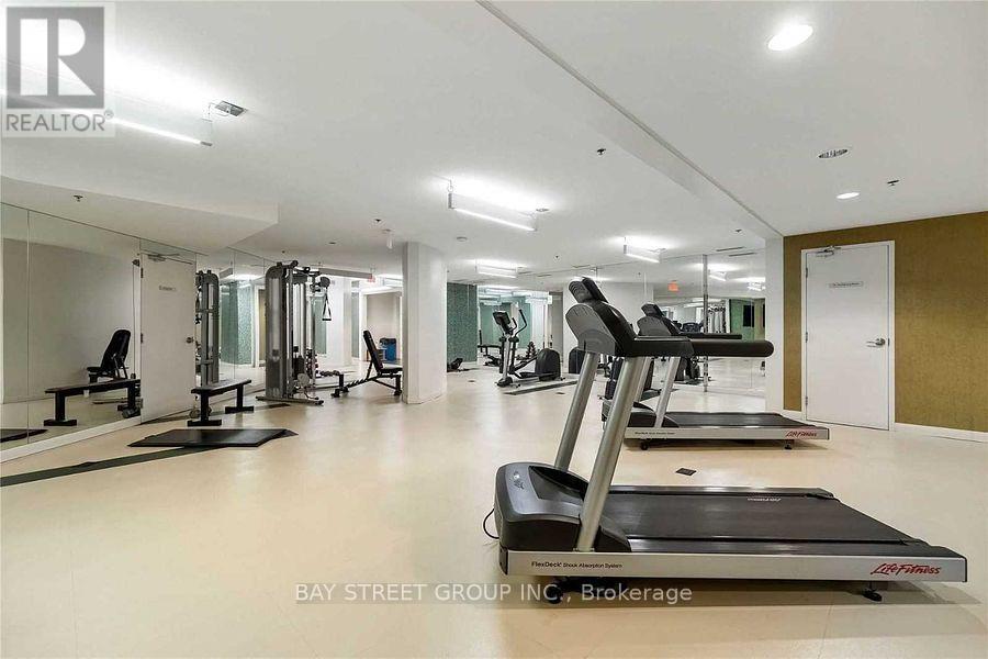 A gym with treadmills, weights, and mirrors.