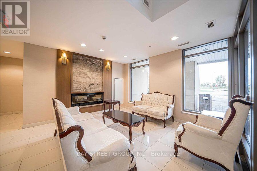A living room with a fireplace and a large painting on the wall.