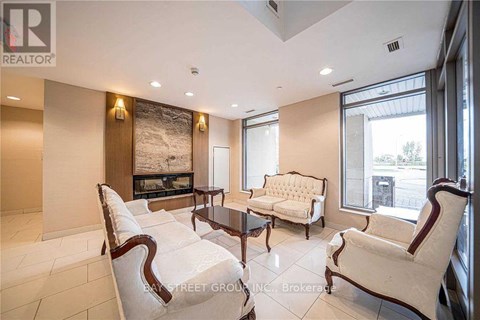 A living room with a fireplace and a large painting on the wall.