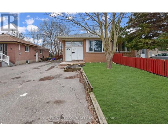 A house with a red fence and a tree in front of it.