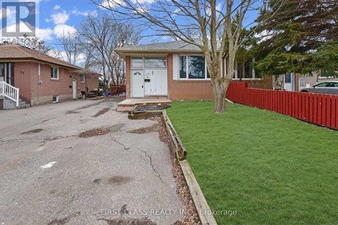 A house with a red fence and a tree in front of it.