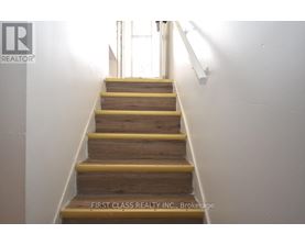A staircase with wooden steps and yellow handrails.