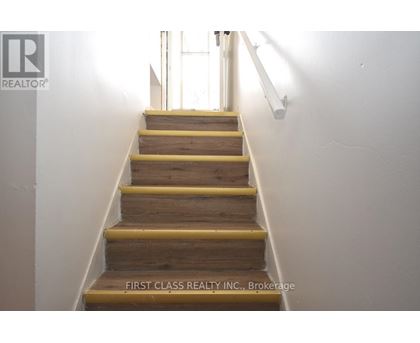 A staircase with wooden steps and yellow handrails.