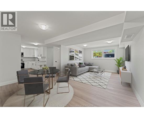 A well-lit, modern living room with a kitchen area in the background.