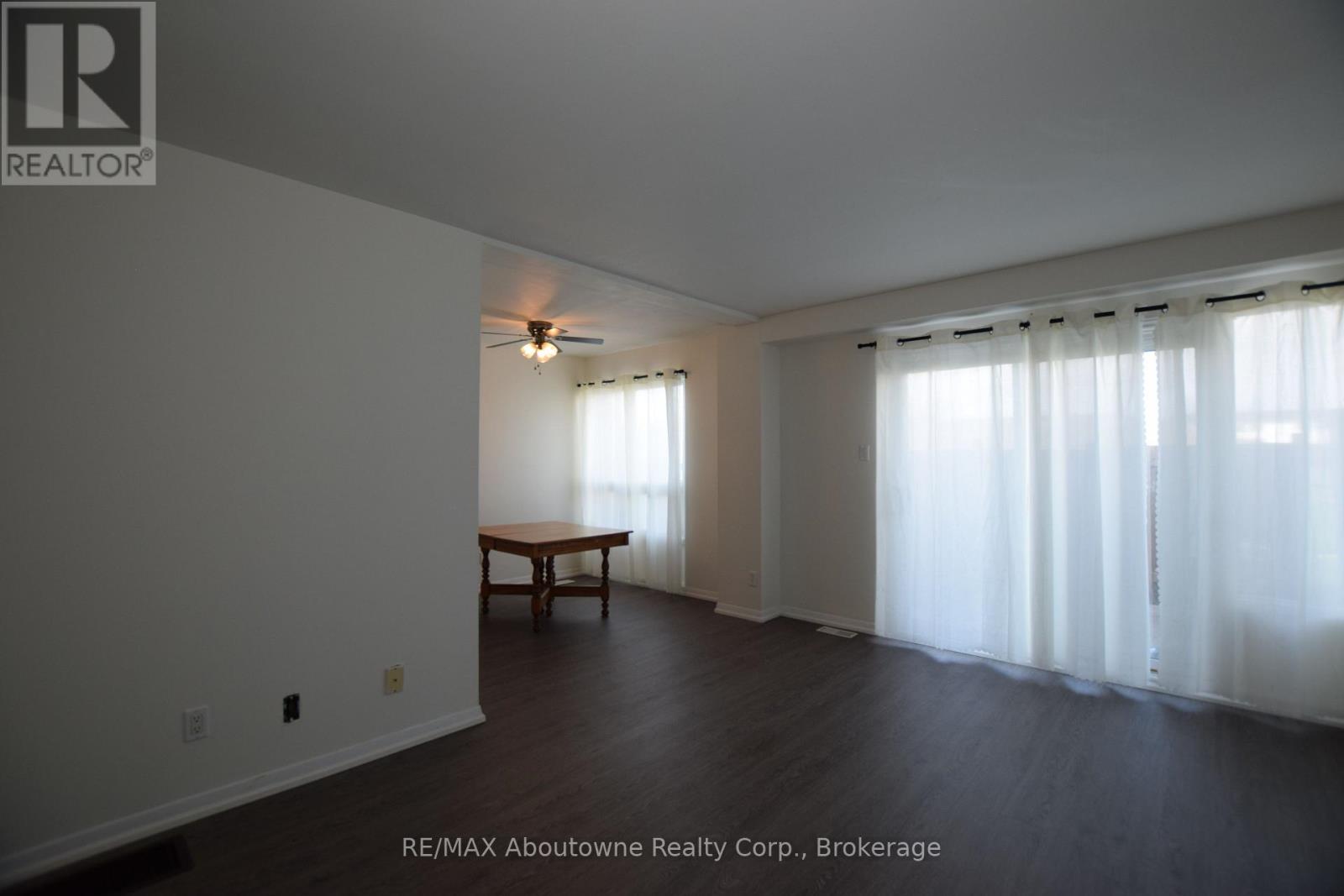 A room with a table and a window with curtains.